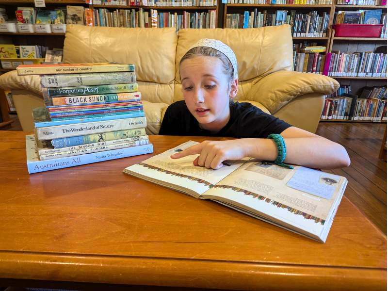Child reading living books from the Wattle Gum Homeschool curriculum