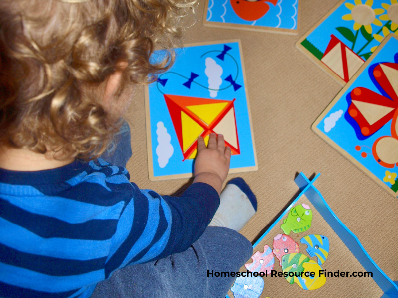 Homeschooling with a toddler. Image of a toddler doing puzzles in a homeschool