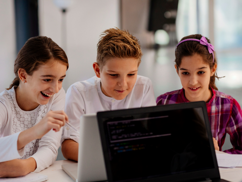 homeschool children learning together on a laptop