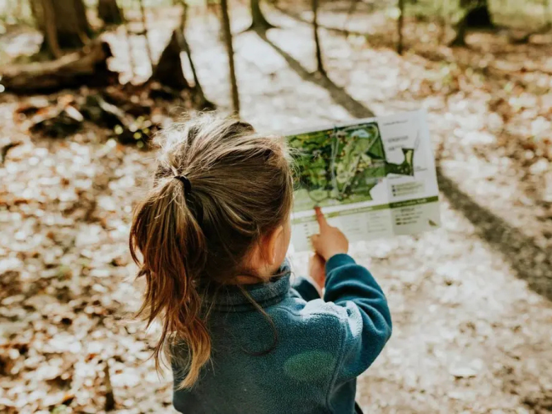 homeschooling child reading a map