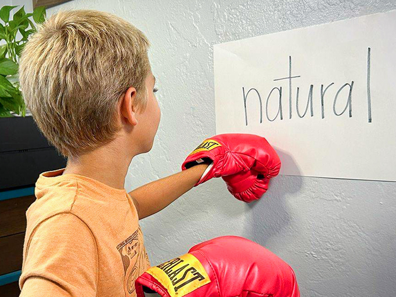 Image of a young boy practising his No Fear Reading lessons.