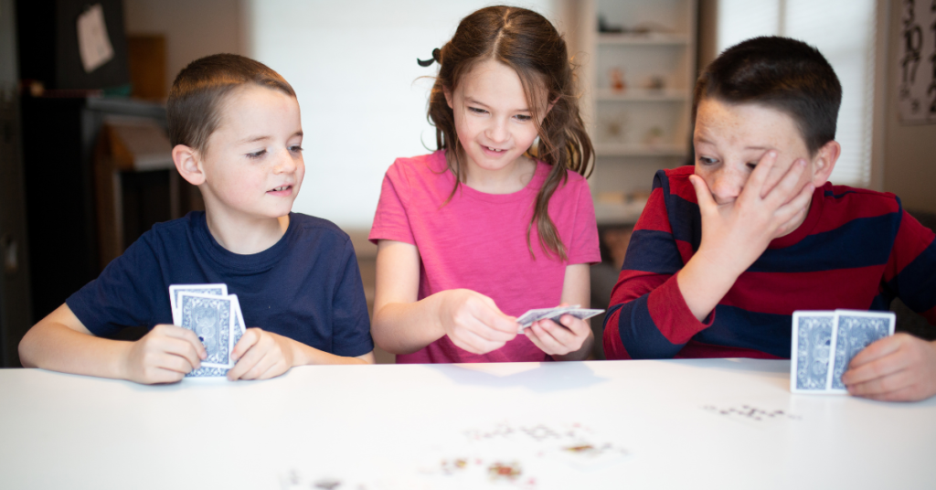 homeschool children playing a mental maths card game