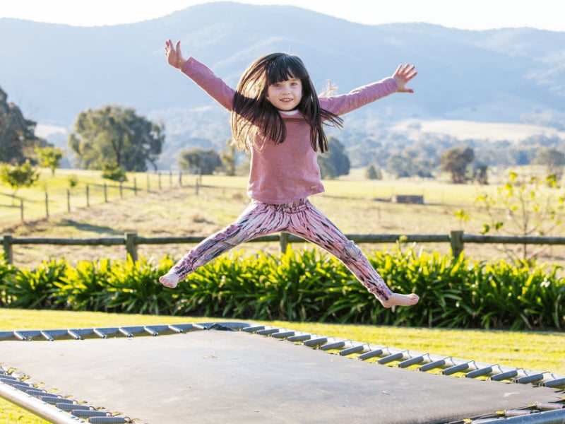 child jumping on a trampoline as a movement break
