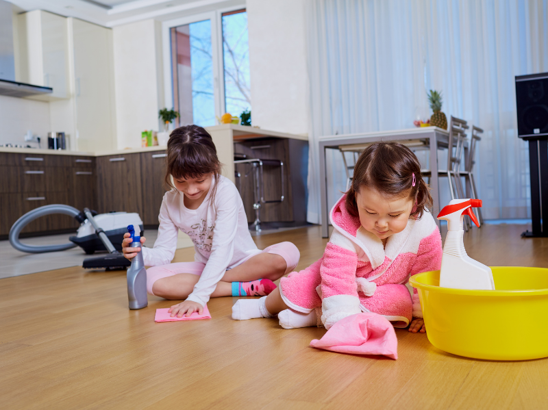 homeschooling children learning to clean the house as part of their every day life skills lessons